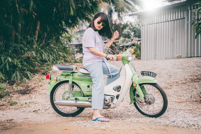 Full length of woman riding bicycle