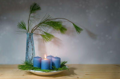 Close-up of illuminated candles on table