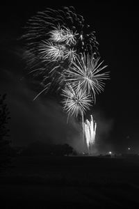 Low angle view of firework display at night