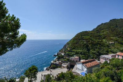 High angle view of buildings by sea against sky