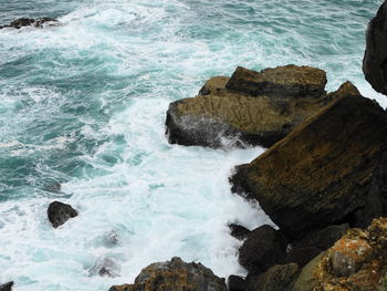 High angle view of rocks in sea