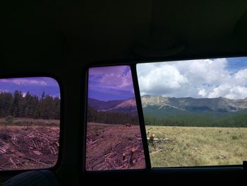 Scenic view of field seen through window