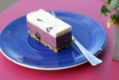 High angle view of blueberry cheesecake dessert in plate on table