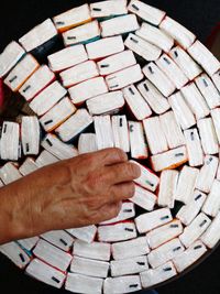 High angle view of man holding multi colored pencils