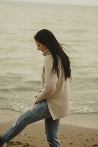 Young woman standing at beach