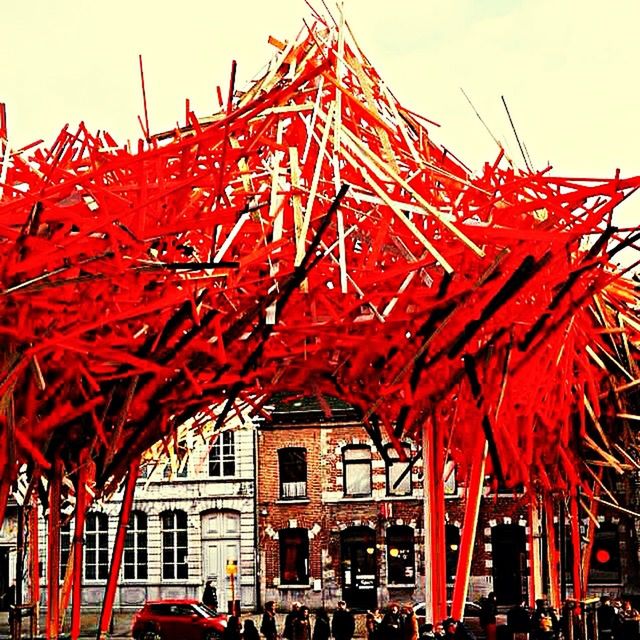 red, building exterior, architecture, built structure, low angle view, religion, day, spirituality, outdoors, place of worship, tradition, tree, cultures, sky, flag, incidental people, history, temple - building, clear sky, travel