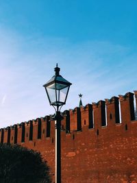 Low angle view of street light against building