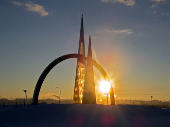 Silhouette built structure against sky during sunset