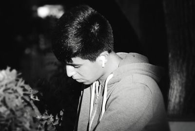 Portrait of young man looking away outdoors