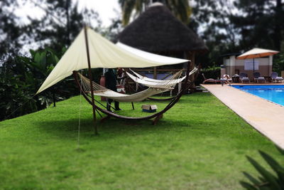 Lounge chairs by swimming pool at yard