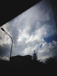 Low angle view of building against cloudy sky