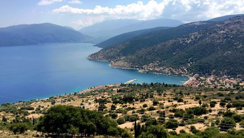 Scenic view of sea and mountains against sky