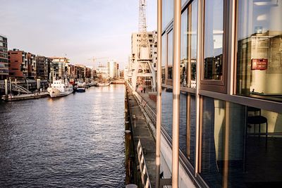 Boats in city against sky