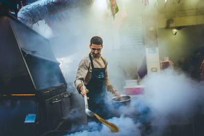 Full length of man working at market stall