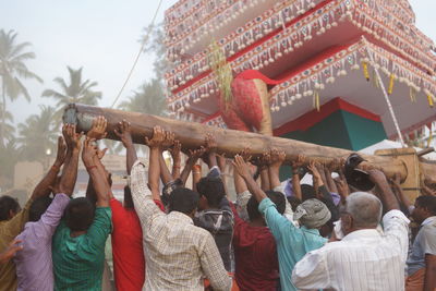 Rear view of people at temple against sky