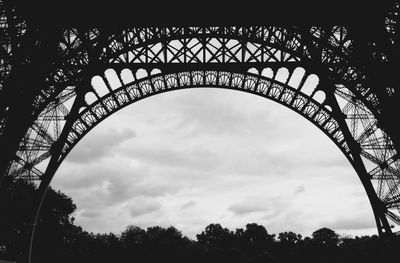 Low angle view of eiffel tower against cloudy sky