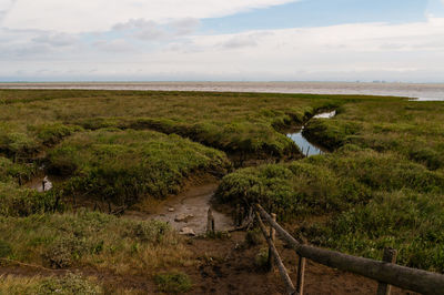 Scenic view of land and sea against sky