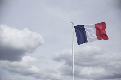 Low angle view of flag against sky