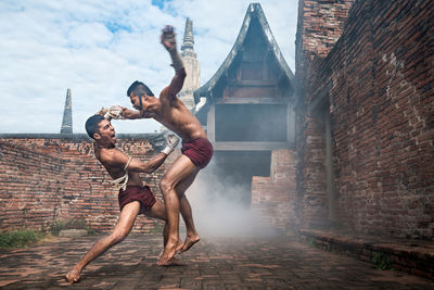 Young couple on wall of building