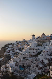 High angle view of townscape by sea against sky