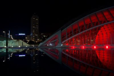 View of illuminated bridge and buildings at night