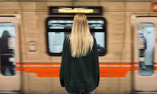 A woman waiting for a train in the subway