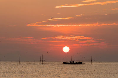 Scenic view of boat on sea against sky during sunset