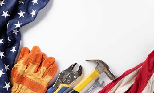 High angle view of tools on table against white background