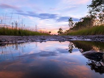 Scenic view of lake against sky at sunset