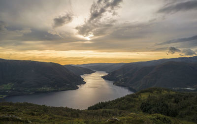 Scenic view of river against sky during sunset