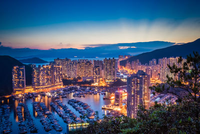 High angle view of illuminated buildings in city at dusk