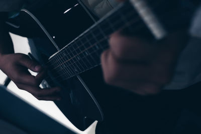 Close-up of man playing guitar