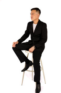 Young man looking away over white background