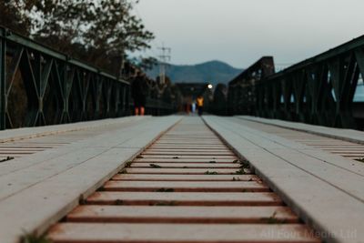 Surface level of footbridge against sky