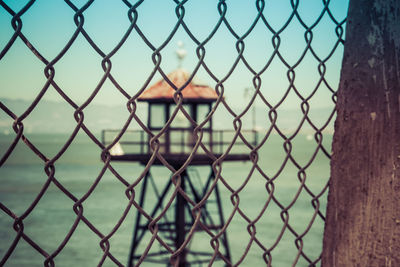 Close-up of chainlink fence against sky