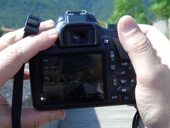 Cropped hands of man photographing
