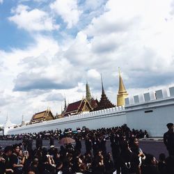 Crowd at temple against sky in city