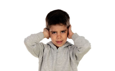 Portrait of boy standing against white background