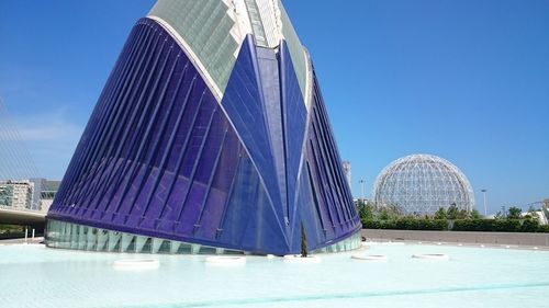 Low angle view of modern building against blue sky