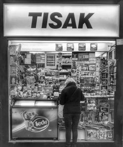 Rear view of woman standing in store