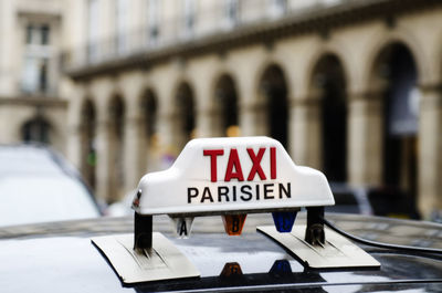 Close-up of information sign on taxi