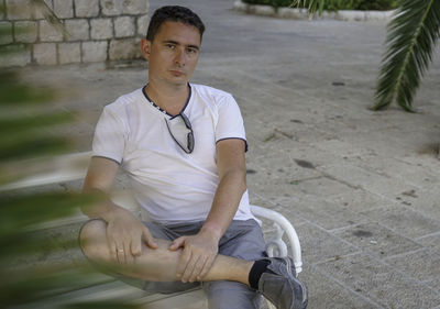 Portrait of mature man sitting on bench