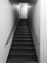 Staircase in illuminated corridor