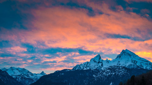 Scenic view of snowcapped mountains against sky during sunset