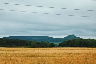 Scenic view of mountains against cloudy sky