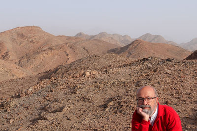 Senior man with red shirt in the desert 