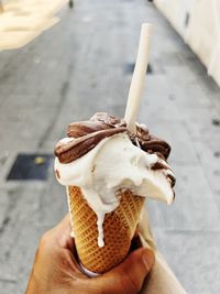 Cropped hand of woman holding ice cream cone