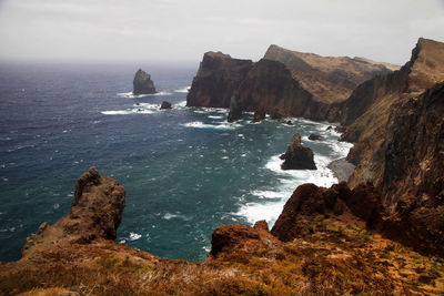 Rock formations on sea against sky