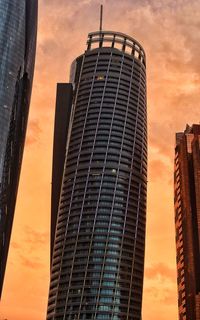 Low angle view of buildings against sky during sunset