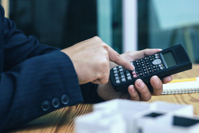 Midsection of man using mobile phone